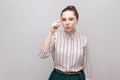 Give me a little bit more please. Portrait of hopeful beautiful young woman in striped shirt with makeup and collected ban