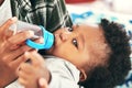 Give me what I want and I wont cry. a mother giving her baby boy bottle. Royalty Free Stock Photo