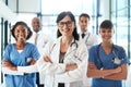 We give our best every single time. Portrait of a diverse team of doctors standing together in a hospital.