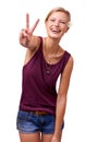 Give peace a chance. Studio portrait of an attractive young woman laughing and giving the peace sign isolated on white. Royalty Free Stock Photo