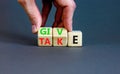 Give or take symbol. Concept word Give or Take on wooden cubes. Beautiful grey table grey background. Businessman hand. Business Royalty Free Stock Photo