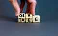 Give or take symbol. Concept word Give or Take on wooden cubes. Beautiful grey table grey background. Businessman hand. Business Royalty Free Stock Photo