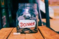 give Text on wooden and money in plastic jar top view,donate written and give text on wooden,top view charity Royalty Free Stock Photo