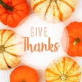 Give Thanks greeting card with frame of pumpkins over white