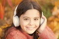 Give in to the groove. Happy child wear headphones. Little music fan on autumn day. Happy little girl in autumn. Little