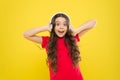 Give in to the groove. Little DJ on yellow background. Cute girl listening to music in DJ headphones. Small child using Royalty Free Stock Photo