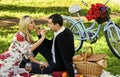 Give uncommon, unique gifts spontaneously. Enjoying their perfect date. Happy loving couple relaxing in park with food Royalty Free Stock Photo