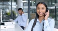 Give us a call if you have more questions. Portrait of a young call centre agent working in an office.