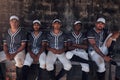 Give us a game of baseball any day. Portrait of a group of young men sitting in the dugout at a baseball game. Royalty Free Stock Photo