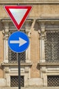 Give way and right arrow direction signs with ancient italian military accademy as background Royalty Free Stock Photo