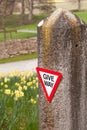 Give way sign on old stone gatepost