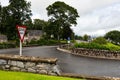 Give Way traffic sign at T-junction in a small Scottish town of Dufftown after light rain