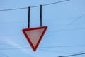 Give way Yield - red and white triangle. Clear blue sky is behind road sign Royalty Free Stock Photo