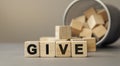 Give - word concept from wooden blocks on desk