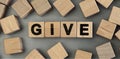 Give - word concept from wooden blocks. Top view