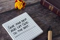 Give your best and let God do the rest, inspiring Christian quote on note paper with holy bible, pen, and flower on wooden table