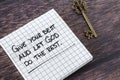 Give your best and let God do the rest, inspiring handwritten quote with ancient key on wooden table