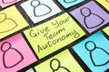 Give Your Team Autonomy and drawn smiles faces Royalty Free Stock Photo