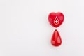 Giving blood saves live. Blood Donation concept. Red heart and blood drop on white background