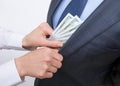 Giving a bribe into a pocket Royalty Free Stock Photo