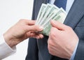 Giving a bribe into a pocket Royalty Free Stock Photo