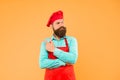 Giving a catering solution. bearded chef pointing finger. brutal male cook in hat and apron. professional man cooking Royalty Free Stock Photo