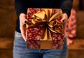 Giving christmas present, woman holding gift box.