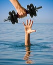 Giving dumbbell to sinking man instead of help. Making worse. Royalty Free Stock Photo