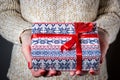 Giving a gift, handmade present wrapped in paper. Christmas time. Royalty Free Stock Photo