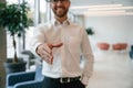 Giving hand to make handshake. Elegant man in formal clothes is indoors Royalty Free Stock Photo