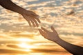 Giving a help hand concept. Reaching hand helping, hope and support each other over sunset