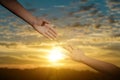 Reaching hand helping, hope and support each other over sunset background Royalty Free Stock Photo