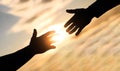 Giving a helping hand. Rescue, helping gesture or hands. Mercy, two hands silhouette on sky background, connection or