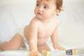 Giving her expanding mind all the stimulation it needs. An adorable baby girl looking sideways with wooden blocks lying Royalty Free Stock Photo