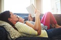 Giving her little girl the gift of literacy. a mother and her daughter reading a book together on the sofa at home. Royalty Free Stock Photo