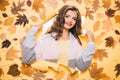 Giving her skintone a boost. Make-up trends for autumn. Fall look. Makeup girl peek through torn paper. Pretty girl look Royalty Free Stock Photo