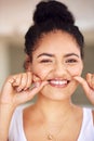 Giving her smile a thorough cleaning. Portrait of a young woman flossing her teeth. Royalty Free Stock Photo