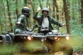 Giving high fives by the hands. Two male atv riders is in the forest together Royalty Free Stock Photo