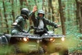 Giving high fives by the hands. Two male atv riders is in the forest together Royalty Free Stock Photo