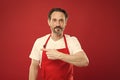 Giving instructions. Cook with beard and mustache wear apron red background. Man mature cook posing cooking apron. Fine