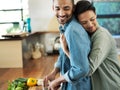 Giving a little bit of love to the chef. an affectionate young couple preparing a meal together in their kitchen. Royalty Free Stock Photo