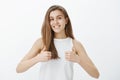 Giving my approval. Portrait of good-looking friendly and outgoing girl with blond hair, showing thumbs up and smiling