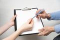 Giving paper and pen to elderly parent. Helping elderly people concept Royalty Free Stock Photo