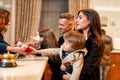 Giving a reason to smile. Happy family checking in hotel at reception desk. Receptionist is giving a toy for a boy while Royalty Free Stock Photo