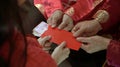 Giving red envelop for Chinese New Year Top view grandparent and five money to child Royalty Free Stock Photo