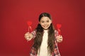 Giving a special valentine heart. Small girl giving hearts on sticks. Cute girl with small red hearts. Small child with