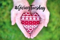 Giving Tuesday concept with red heart in hands