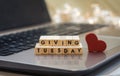 GIVING TUESDAY letter blocks concept on laptop keyboard