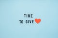 Giving Tuesday, Time to Give, Help, Donation, Support, Volunteer concept with red heart and text Time to Give on blue Royalty Free Stock Photo