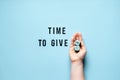 Giving Tuesday, Time to Give, Help, Donation, Support, Volunteer concept with red heart and text Time to Give on blue Royalty Free Stock Photo